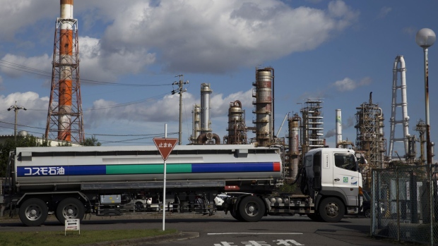 A Cosmo Oil Co. gasoline tanker drives past its refinery at the Yokkaichi industrial complex in Yokkaichi, Mie Prefecture, Japan, on Saturday, Oct. 29, 2016. The Paris Agreement, the most sweeping climate change agreement to combat global warming to date, will enter into force Nov. 4. Photographer: Tomohiro Ohsumi/Bloomberg