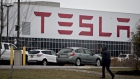 A person walks outside the Tesla Inc. solar panel factory in Buffalo, New York, U.S., on Wednesday, Dec. 26, 2018. Employees at the factory this month kicked off a union-organizing campaign, a fresh challenge to the automaker that has so far successfully resisted similar efforts by the United Auto Workers at its sole car plant in Fremont, California. Photographer: Andrew Harrer/Bloomberg