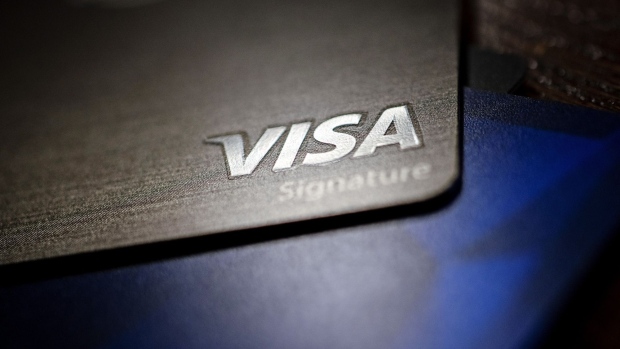 A Visa Inc. credit card is arranged for a photograph in Tiskilwa, Illinois, U.S., on Tuesday, Sept. 18, 2018. Visa and Mastercard agreed to pay as much as $6.2 billion to end a long-running price-fixing case brought by merchants over card fees, the largest-ever class action settlement of an antitrust case. Photographer: Daniel Acker/Bloomberg