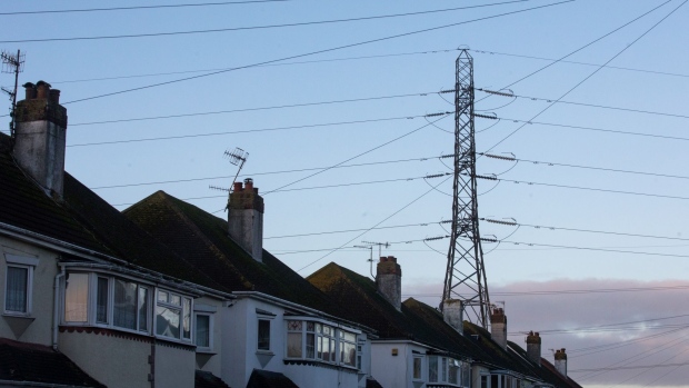 An electricity transmission pylon above residential houses in Brighton, U.K., on Thursday, Nov. 12, 2020. Brexit talks are going down to the wire, and the European Union's chief negotiator Michel Barnier is threatening British access to the continent's single energy market as a way of extracting concessions on fishing rights.
