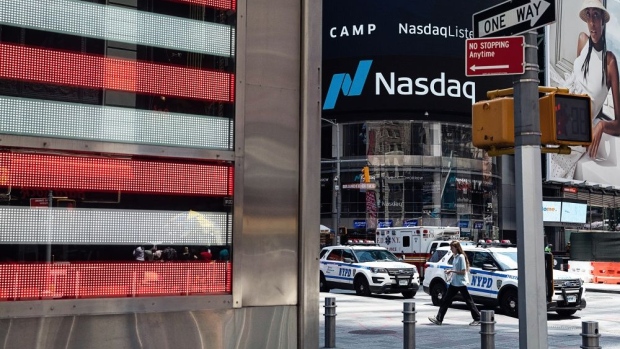 Signage is displayed outside the Nasdaq MarketSite in the Times Square neighborhood of New York, U.S., on Monday, July 20, 2020. U.S. stocks fluctuated in light trading as investors are keeping an eye on Washington, where lawmakers will begin hammering out a rescue package to replace some of the expiring benefits earlier versions contained. Photographer: Bloomberg/Bloomberg