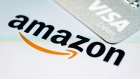 LONDON, ENGLAND - NOVEMBER 17: In this photo illustration, a Visa credit card is seen above the Amazon logo on the mobile app splash screen on November 17, 2021 in London, England. The online retail giant cited Visa's high service fees for its decision to stop accepting UK-issued Visa credit cards for payment. The decision, which is to take effect January 19 of next year, only applies to Visa credit cards, not debit cards. (Photo illustration by Leon Neal/Getty Images)