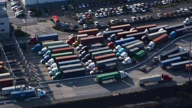Trucks enter and exit the Port of Los Angeles on Nov. 16.