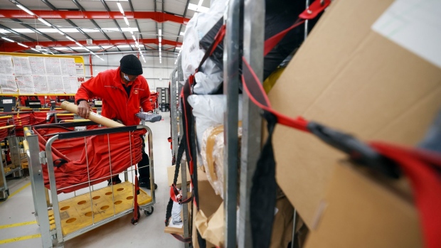 An employee sorts through a trolley of parcels the Royal Mail Plc sorting office in Chelmsford, U.K., on Thursday, May 13, 2021. Royal Mail are due to report earnings on Thursday, May 20. Photographer: Chris Ratcliffe/Bloomberg
