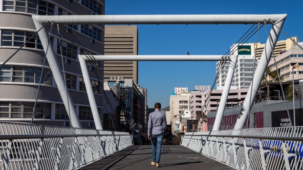 A pedestrian uses the Fan Walk foot bridge over Buitengracht Street in Cape Town, South Africa, on Thursday, July 23, 2020. South Africa’s surging coronavirus infections and the resumption of rolling blackouts are clouding the outlook for the economy. Photographer: Dwayne Senior/Bloomberg