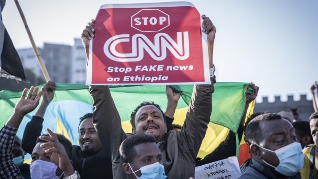 ADDIS ABABA, ETHIOPIA - NOVEMBER 07: A man holds a placard to protest against CNN news media as a ceremony is held to support the Ethiopian military troops who is battling against the Tigrays People Liberation Front in Amhara Region on November 7, 2021 in Addis Ababa, Ethiopia. The country's Prime Minister Abiy Ahmed declared a state of emergency on Wednesday as his government's conflict with Tigrayan forces has expanded beyond that group's home region in the north. Tigrayan fighters have recently forged an alliance with the Oromo Liberation Army, a group fighting on behalf of ethnic Oromos, who make up about 35 percent of Ethiopia's 110 million people. (Photo by Getty Images/Getty Images)