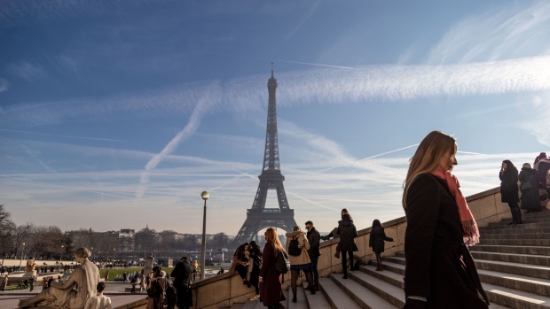 Tourists visit Trocadero Place for views of the Eiffel Tower in Paris, France, on Tuesday, Dec. 31, 2019. The French government is hoping the strikes against its pension reform plans may be starting to wind down as President Emmanuel Macron prepares to make his traditional New Year's address. Photographer: Anita Pouchard Serra/Bloomberg