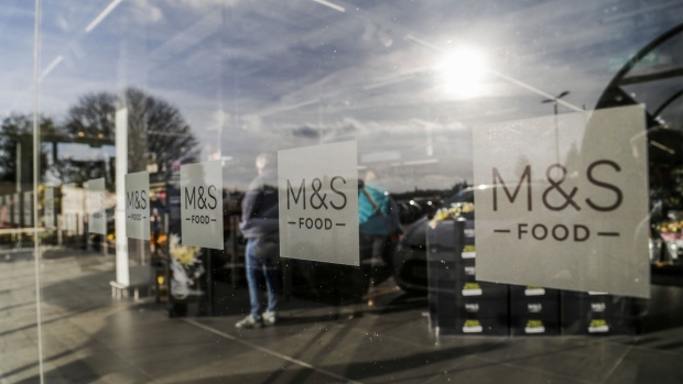 The M&S logo sits on a window at Marks and Spencer Group Plc's newly opened store in Fraddon, U.K. on Wednesday, Oct. 23, 2019. Marks & Spencer plans to open more large food stores, shifting away from a strategy of expanding smaller convenience outlets as it prepares for an alliance with online grocer Ocado Group Plc. Photographer: James Beck/Bloomberg