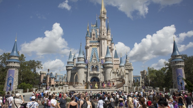 Visitors watch a performance at the Cinderella Castle at the Walt Disney Co. Magic Kingdom park in Orlando, Florida, U.S., on Tuesday, Sept. 12, 2017. The Walt Disney Co. Magic Kingdom park reopened to a smaller-than-usual crowd after closing for two days and suffering minor storm damage from Hurricane Irma. Photographer: David Ryder/Bloomberg