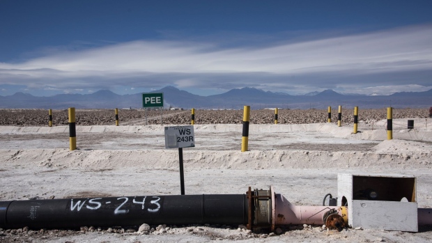 A pumping pipe lies across the ground at a Sociedad Química y Minera de Chile (SQM) lithium mine on the Atacama salt flat in the Atacama Desert, Chile, on Wednesday, May 29, 2019. Almost three-quarters of the world’s lithium raw materials come from mines in Australia or briny lakes in Chile, giving them leverage with customers scrambling to tie-up supplies. The mining nations hope to bring refining and manufacturing plants that could help kickstart domestic technology industries.