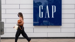 A person wearing a protective mask walks in front of a Gap Inc. store in Corte Madera, California, U.S., on Tuesday, March 2, 2021. Gap Inc. is scheduled to release earnings figures on March 4. Photographer: David Paul Morris/Bloomberg