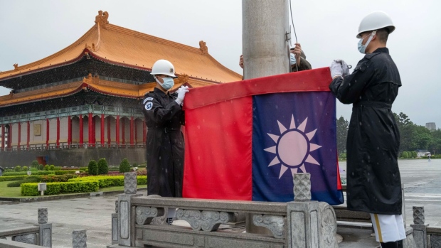 Honor guards wearing protective masks raise a Taiwanese flag at the National Chiang Kai-shek Memorial Hall in Taipei, Taiwan, on Wednesday, June 3, 2021. Taiwan’s ruling party said it plans to double a proposed increase in stimulus funding as the economy reels from tightening virus restrictions across the island. Photographer: Billy H.C. Kwok/Bloomberg