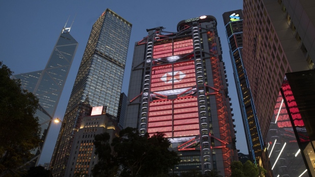 The HSBC Holdings Plc headquarters building, center, stands illuminated at dusk in Hong Kong, China, on Monday, April 27, 2020. HSBC is scheduled to release first-quarter earnings results on April 28. Photographer: Roy Liu/Bloomberg