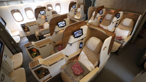 Seating configurations stand in a business class cabin on board a Boeing Co. 777-300ER passenger jetliner, operated by Emirates Airline, at London Stansted Airport in Stansted, U.K.