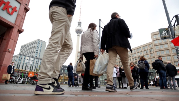Shoppers on Alexanderplatz square in central Berlin, Germany, on Tuesday, Oct. 26, 2021. German business confidence took another hit in October as global supply logjams damp momentum in the manufacturing-heavy economy. Photographer: Liesa Johannssen-Koppitz/Bloomberg