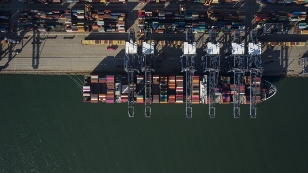 Gantry cranes load cargo onto container ship anchored at the Yantian International Container Terminals, operated by CK Hutchison Holdings Ltd.'s Hutchison Port Holdings Trust (HPH Trust), in this aerial photograph taken in Shenzhen, China, on Friday, Sept. 6, 2019. Shenzhen is young, hopeful and looks optimistically toward a future where it can help drive China’s push to dominate the next century through an innovative economy that sidesteps political freedoms. The city also has the centralized control, relentless efficiency and advanced manufacturing that lie at the root of President Xi Jinping’s concept of China’s future greatness. Photographer: Qilai Shen/Bloomberg