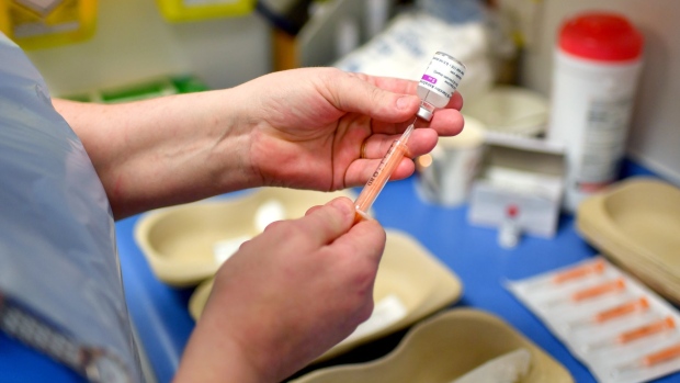 A nurse draws the AstraZeneca Plc and the University of Oxford Covid-19 vaccine into a syringe at the Royal Health & Wellbeing Centre in Oldham, U.K., on Thursday, Jan. 21, 2021. Boris Johnson's government is pinning its hopes on a mass vaccination program to reduce hospitalizations and ultimately deaths, and aims to slowly lift restrictions from March to allow the economy to re-open. Photographer: Anthony Devlin/Bloomberg