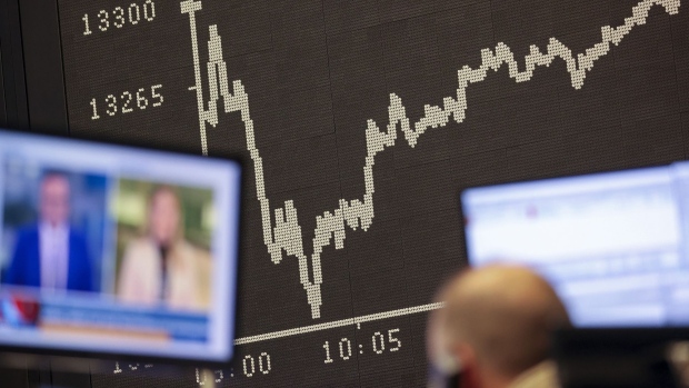 A trader watches news on a television monitor as the DAX Index yield curve shows a drop at the Frankfurt Stock Exchange. Photograph: Alex Kraus/Bloomberg