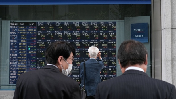 An electronic stock board outside a securities firm in Tokyo, Japan, on Tuesday, Sept. 7, 2021. The Nikkei 225 Stock Average touched a level above 30,000 for the first time since April as a reshuffle of the blue-chip gauge added to a wave of positive sentiment on Japanese equities. Photographer: Soichiro Koriyama/Bloomberg