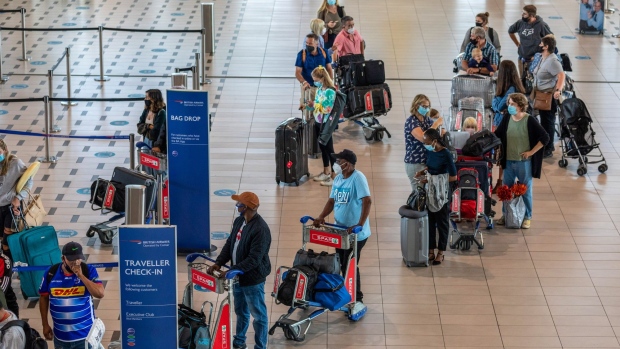Travelers queue at a British Airways check-in area inside the departures terminal at Cape Town International Airport in Cape Town, South Africa, on Wednesday, March 31, 2021. Travel and tourism contributed 7% to South Africas gross domestic product in pre-pandemic times, according to the World Travel and Tourism Council.