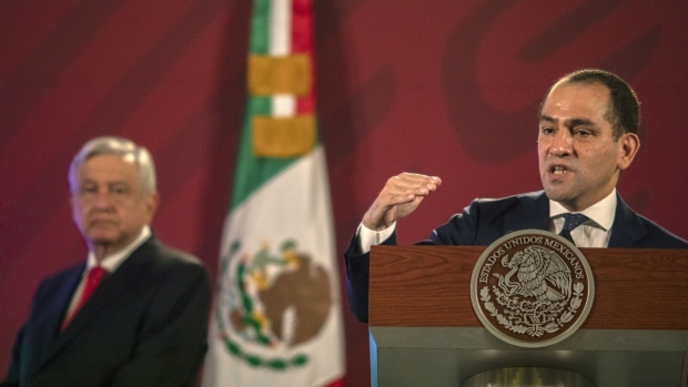 Arturo Herrera, Mexico's finance minister, speaks while Andres Manuel Lopez Obrador, Mexico's president, left, listens during a news conference at the National Palace in Mexico City, Mexico, on Wednesday, July 22, 2020. Lopez Obrador presented a plan to overhaul the nation's $266 billion pension system, seeking to have companies pay more toward employee retirement funds, in a rare display of unity with business leaders.