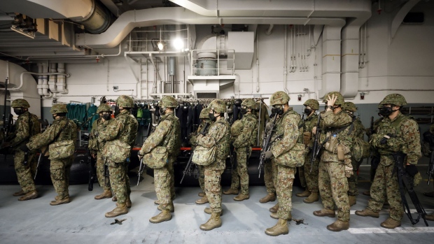 Members of the Japan Ground Self-Defense Force (JGSDF) prepare to board a Japan Maritime Self-Defense Force (JMSDF) Landing Craft Air Cushion (LCAC) from the JMSDF JS Kunisaki tank landing ship during a joint exercise by the Japan Self-Defense Forces (JSDF) off the coast of Tanegashima island in Kagoshima, Japan, on Thursday, Nov. 25, 2021. Japan has openly expressed concerns about tensions across the Taiwan Strait and their effect on regional security.