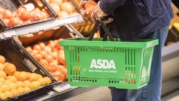 A customer holds a basket of groceries inside an Asda store, trialing new sustainability initiatives, in Middleton, U.K. Photographer: Anthony Devlin/Bloomberg