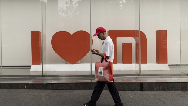 A pedestrian in front of a Xiaomi Corp. store in Shanghai, China, on Tuesday, Aug. 24, 2021. Xiaomi is scheduled to release earnings results on Aug. 25. Photographer: Qilai Shen/Bloomberg