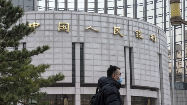 A pedestrian walks past the People's Bank of China (PBOC) building in Beijing, China, on Thursday, March 4, 2021. The low cost of borrowing in China’s money markets suggests the central bank again has room to tighten policy by withdrawing liquidity from the financial system -- like it did in January. Photographer: Qilai Shen/Bloomberg