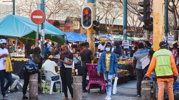 Shoppers walk through a market in the central business district (CBD) of Pretoria, South Africa, on Tuesday, Sept. 14, 2021. South Africa's government met Tuesday to discuss how to accelerate the country's economic recovery and consider the most feasible way to provide further welfare grants.