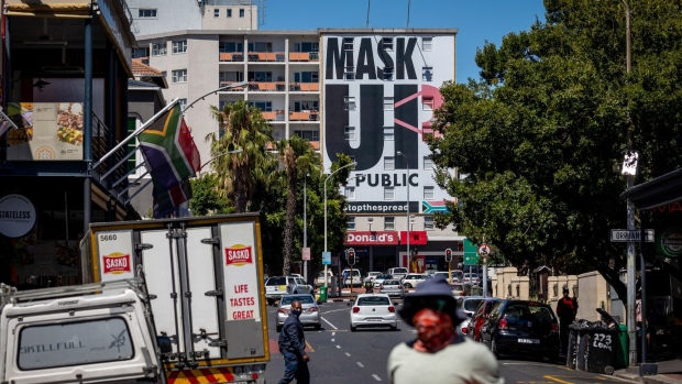 A 'mask up' billboard covers the front of a building on Long Street in Cape Town, South Africa, on Monday, Jan. 11, 2021. The pandemic and restrictions imposed to contain it have devastated Africa's most industrialized economy, and the extension of curbs that came into effect at the height of the holiday season bode ill for efforts to engineer a rebound.