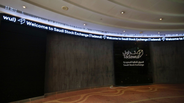 A logo and digital welcoming message sit on display at the entrance to the Saudi Stock Exchange, also known as Tadawul, in Riyadh, Saudi Arabia, on Sunday, Nov. 4, 2018. A month after the murder of government critic Jamal Khashoggi in the Saudi consulate in Istanbul, bankers say the rewards of doing business with the oil-rich kingdom far outweigh the risks. Photographer: Mohammed Almuaalemi/Bloomberg