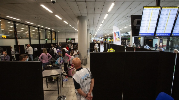 Travelers wait to be admitted into the Covid-19 test center at Schiphol Airport in Amsterdam.