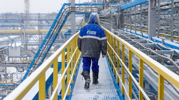 A worker walks along an access platform at the Comprehensive Gas Treatment Unit No.3 of the Gazprom PJSC Chayandinskoye oil, gas and condensate field, a resource base for the Power of Siberia gas pipeline, in the Lensk district of the Sakha Republic, Russia, on Monday, Oct. 11, 2021. Amid record daily swings of as much as 40% in European gas prices, Russian President Vladimir Putin made a calculated intervention to cool the market last week by saying Gazprom can boost supplies to help ease shortages. Photographer: Andrey Rudakov/Bloomberg