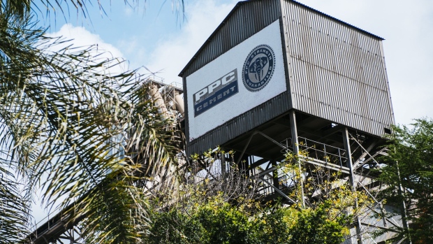 The PPC company logo stands on the exterior of a conveyor belt structure at the PPC Ltd. Hercules cement plant in Pretoria, South Africa, on Tuesday, April 17, 2018. PPC, South Africa's largest cement maker, sees a pick-up in demand in its home market as President Cyril Ramaphosa inspires greater investor confidence and initiates new infrastructure projects. Photographer: Waldo Swiegers/Bloomberg