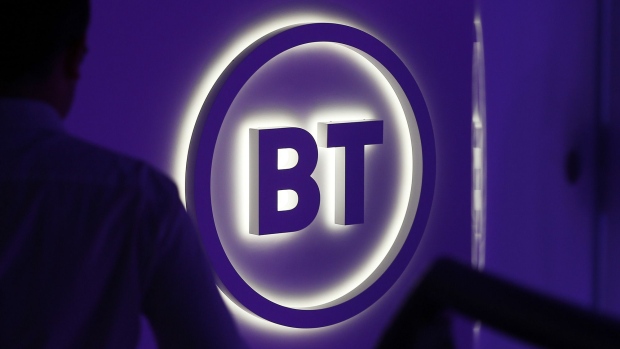 An attendee passes a BT Group Plc logo during a news conference in London, U.K., on Wednesday, Oct. 9, 2019. BT is making a new push to improve customer service, including the arrival of BT-branded shops for the first time in almost two decades, as Chief Executive Officer Philip Jansen begins a charm offensive to defend market share.