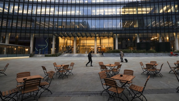 Tables on a cafe terrace outside an office complex in London. Photographer: Chris Ratcliffe/Bloomberg