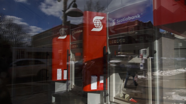 Bank of Nova Scotia signage is displayed on automatic teller machines (ATM) at a bank branch in Toronto, Ontario, Canada, on Monday, Feb. 12, 2018. Bank of Nova Scotia agreed to buy Canadian money manager Jarislowsky Fraser Ltd. for about C$950 million ($755 million), helping push the bank toward its goal of getting more earnings from wealth management. Photographer: Cole Burston/Bloomberg