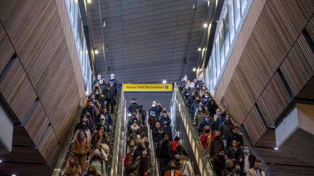 Commuters disembark trains at London Bridge railway station during the morning rush hour, on the day the tougher pandemic rules take effect, in London, U.K., on Tuesday, Nov. 30, 2021. The U.K. will offer Covid booster shots to all adults and second doses to more children amid worries that the new omicron variant could fuel another surge in cases and impact the effectiveness of vaccines. Photographer: Chris J. Ratcliffe/Bloomberg