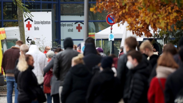 Visitors queue for Covid-19 vaccinations at the Messe Berlin exhibition center in Berlin, Germany, on Monday, Nov. 15, 2021. The three German parties negotiating a government coalition -- the Social Democrats, Free Democrats and Greens -- are planning to tighten restrictions on unvaccinated people, according to Oliver Krischer, the deputy head of the Greens caucus in German parliament.