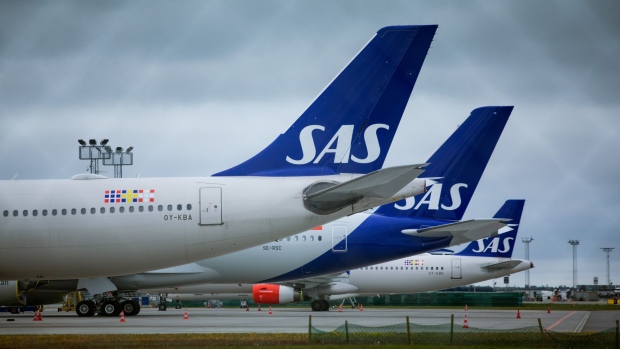 Passenger aircraft, operated by SAS AB, sit parked on the tarmac at Copenhagen Airport in Copenhagen, on April 29.