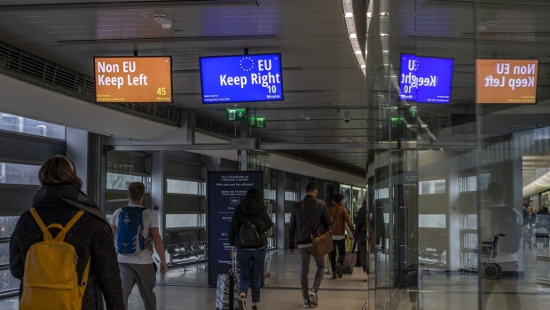 Digital signs direct arriving passengers to non-European Union (EU), left, and EU passport clearance, right, at Dublin Airport in Dublin.