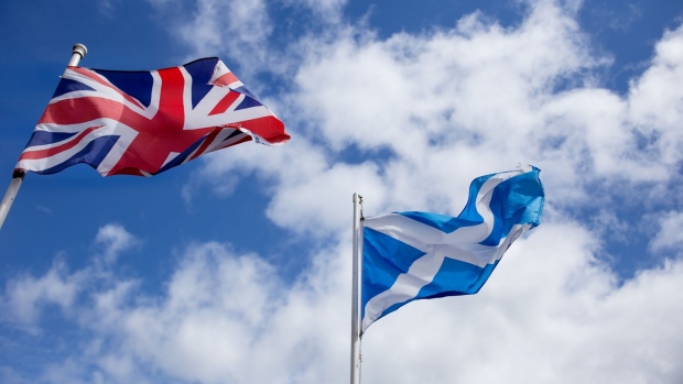 The British Union flag, also known as the Union Jack, left, and the saltire, the national flag of Scotland, right, in a garden in North Ayrshire, U.K., on Thursday, April 29, 2021. Scotland heads into an election on May 6 that's become a pitched battle over whether the nation should get another say on its place in the U.K. after Brexit. Photographer: Emily Macinnes/Bloomberg
