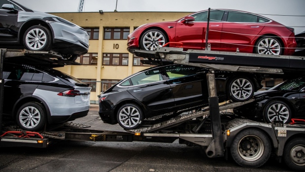 Automobiles produced by Tesla Inc. sit a car transporter truck after arriving on the Glovis Courage vehicles carrier vessel at the Port of Oslo in Oslo.