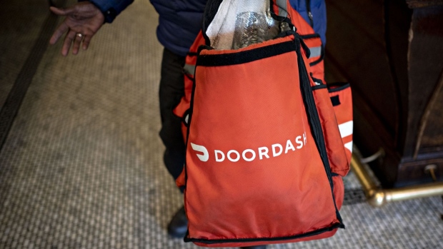A DoorDash Inc. delivery person holds an insulated bag at Chef Geoff's restaurant in Washington, D.C., U.S., on Thursday, March 26, 2020. As the wheels of government turn too slowly for small businesses desperate for a piece of the $2 trillion U.S. relief package due to the coronavirus pandemic, restaurateur Geoff Tracy is using GoFundMe to raise money for 150 hourly workers at his American comfort food standby Chef Geoff's and other restaurants. Photographer: Andrew Harrer/Bloomberg