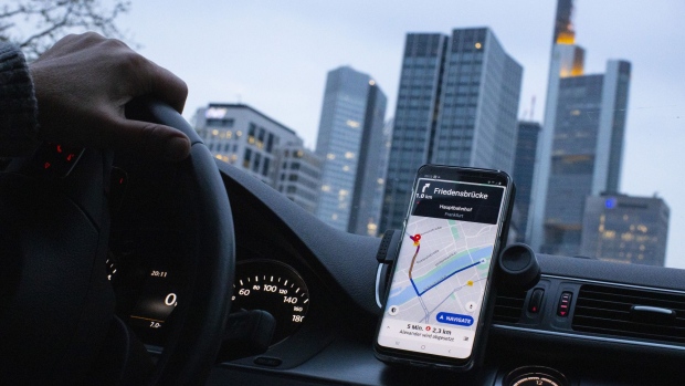 A dashboard-mounted smartphone displays the Uber Technologies Inc. app as an Uber X driver heads towards skyscrapers in the 'Mainhattan' financial district in Frankfurt, Germany, on Friday, April 12, 2019. Uber's long-awaited roadshow for what is expected to be 2019's biggest U.S. IPO is expected to kick off on April 26. Photographer: Alex Kraus/Bloomberg
