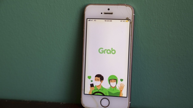 The Grab Holdings Inc. app is displayed on a smartphone in an arranged photograph taken in Singapore, on Friday, Sept. 25, 2020. Alibaba Group Holding Ltd. is in talks to invest $3 billion in Southeast Asian ride-hailing giant Grab, according to people familiar with the matter. Photographer: Ore Huiying/Bloomberg