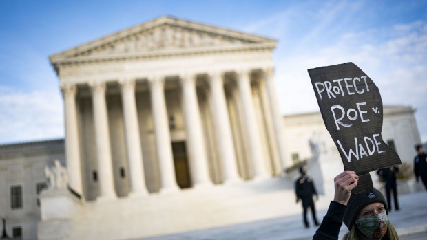 A demonstrator holds a "Protect Roe v. Wade" sign outside the U.S. Supreme Court following oral arguments in the Dobbs v. Jackson Women's Health case in Washington, D.C., U.S., on Wednesday, Dec. 1, 2021. The Supreme Court's conservatives suggested they are poised to curb abortion rights and uphold Mississippi's ban on the procedure after 15 weeks of pregnancy, as the court tackled its most consequential reproductive-rights case in a generation. Photographer: Al Drago/Bloomberg