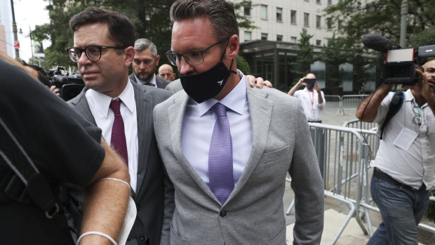 Trevor Milton, center, exits federal court in New York in July.