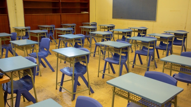 Desks and chairs stand in a classroom at the CMA Secondary School ahead of its scheduled reopening in Hong Kong, China, on Friday, May 15, 2020. While Hong Kong's school shutdown has been among the longest in the world, nearly 160 countries have closed schools during the pandemic, affecting more than 1.2 billion students, according to the United Nations Educational, Scientific and Cultural Organization. Photographer: Billy H.C. Kwok/Bloomberg